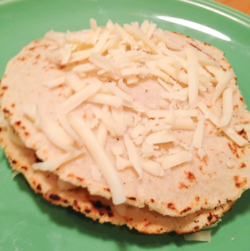 Stacking tortillas with cheese in preparation for huevos rancheros